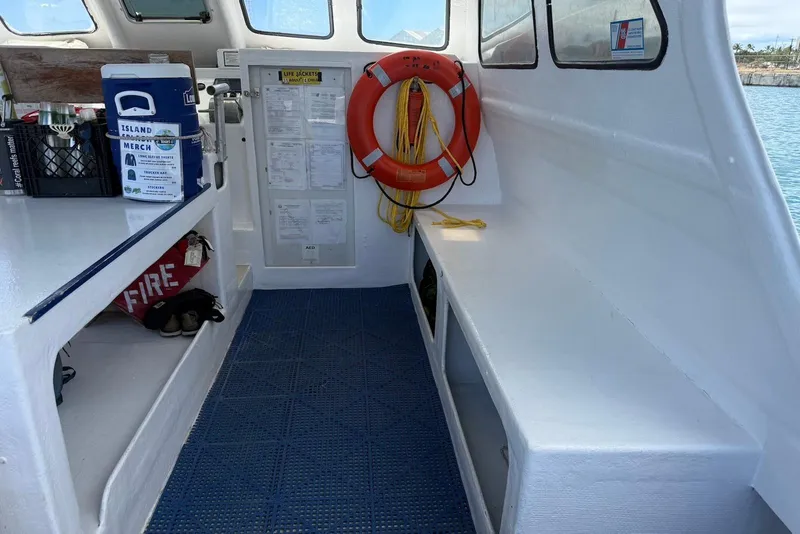 Slide: The Image of Interior of a 2001 Force Power Cat boat with safety equipment and storage. - 12
