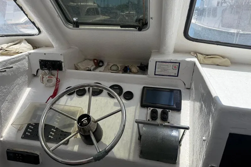 Slide: The Image of 2001 Force Power Cat boat cockpit with steering wheel and navigation controls. - 13