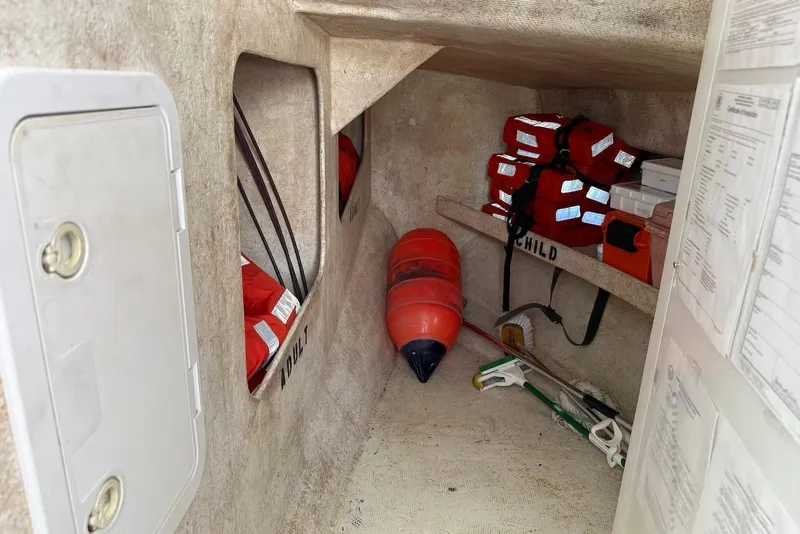 Slide: The Image of Storage area in a 2001 Force Power Cat with life jackets and safety equipment. - 18