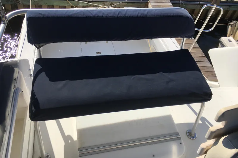 Slide: The Image of Boat seating on a 2000 Phoenix 29 SFX, featuring cushioned navy upholstery. - 11