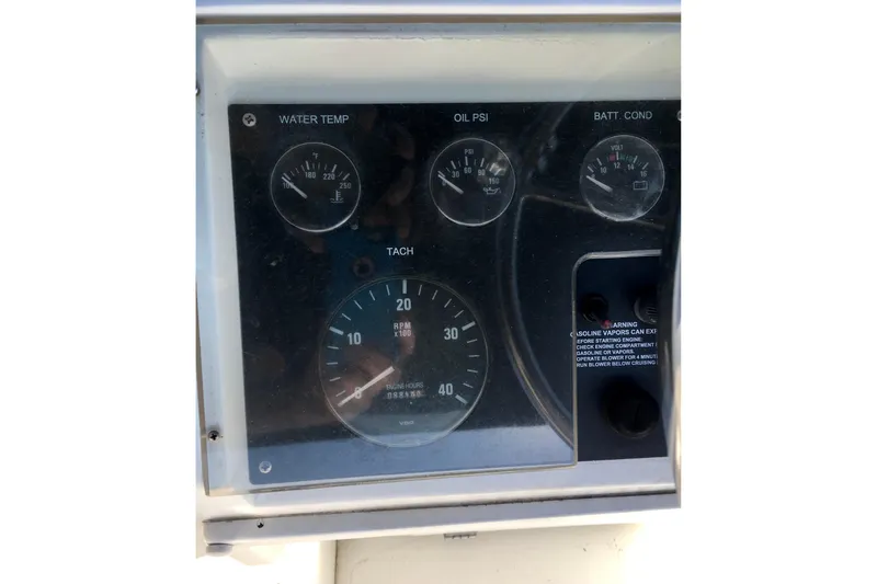 Slide: The Image of Dashboard of a 2000 Phoenix 29 SFX boat with gauges for water temperature, oil pressure, and battery condition. - 12