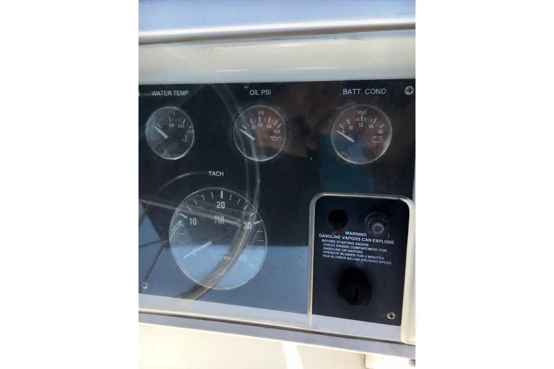 Slide: The Image of Dashboard gauges of a 2000 Phoenix 29 SFX boat, showing water temp, oil PSI, and battery condition. - 13