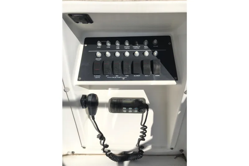 Slide: The Image of Control panel of a 2000 Phoenix 29 SFX boat with switches and radio. - 15