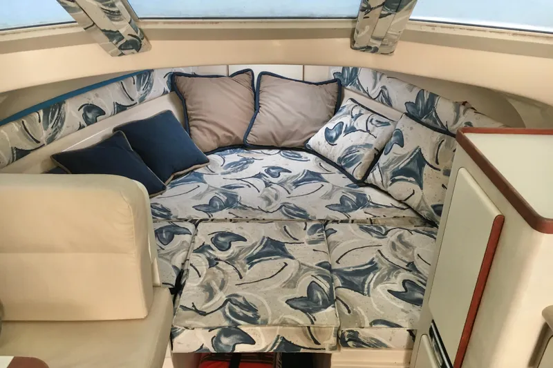 Slide: The Image of Cozy cabin interior of 2000 Phoenix 29 SFX with floral-patterned cushions and pillows. - 17