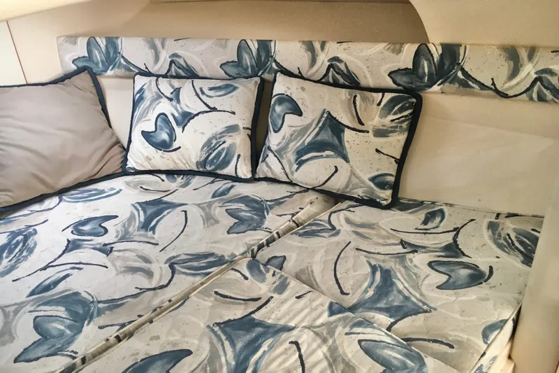 Slide: The Image of Interior of 2000 Phoenix 29 SFX boat with abstract-patterned bedding and cushions. - 18