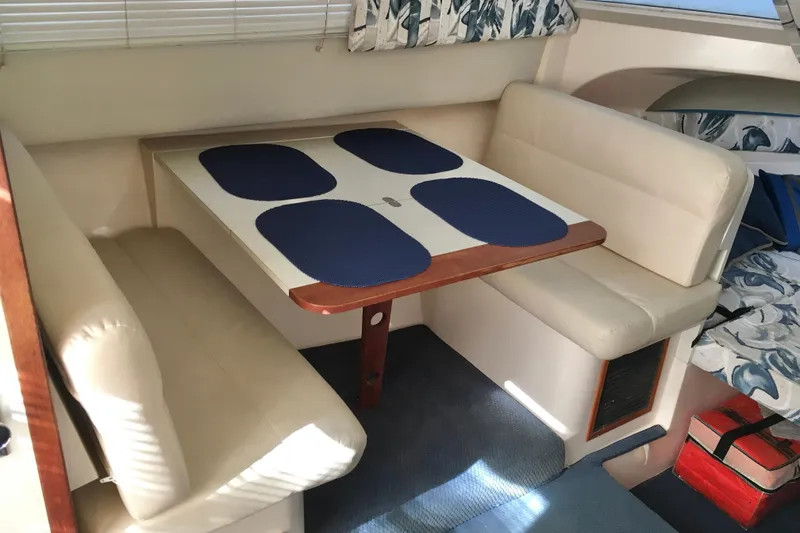 Slide: The Image of Interior of 2000 Phoenix 29 SFX boat with dining area and cushioned seating. - 21