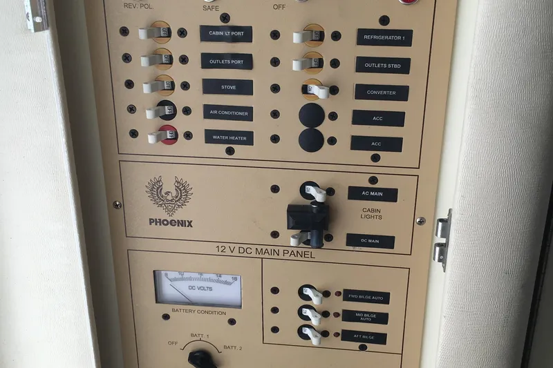 Slide: The Image of Electrical control panel of a 2000 Phoenix 29 SFX boat, featuring various switches and labels. - 26