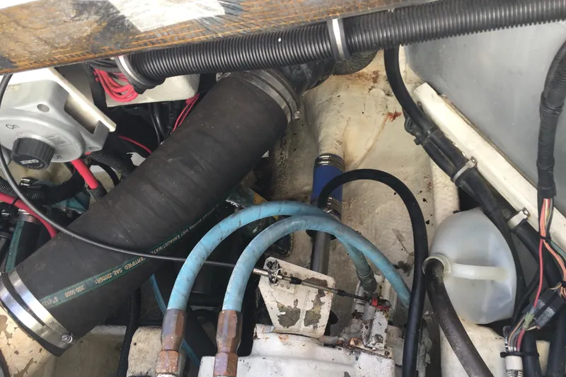 Slide: The Image of Engine compartment of a 2000 Phoenix 29 SFX boat with hoses and wiring. - 28
