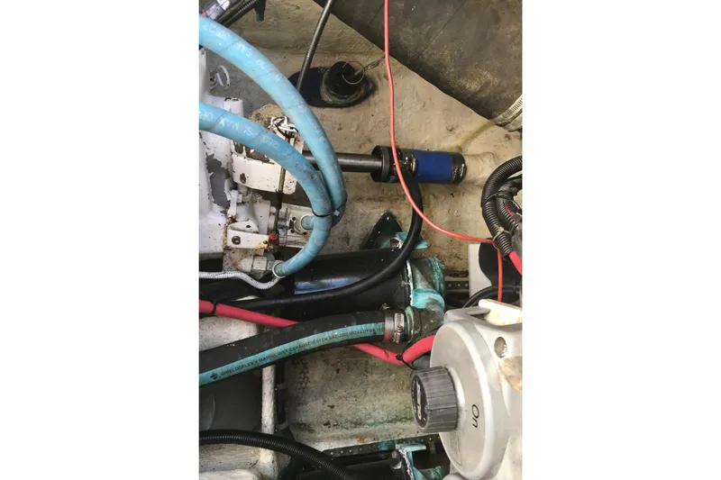 Slide: The Image of Engine compartment of a 2000 Phoenix 29 SFX boat with visible hoses and wiring. - 29