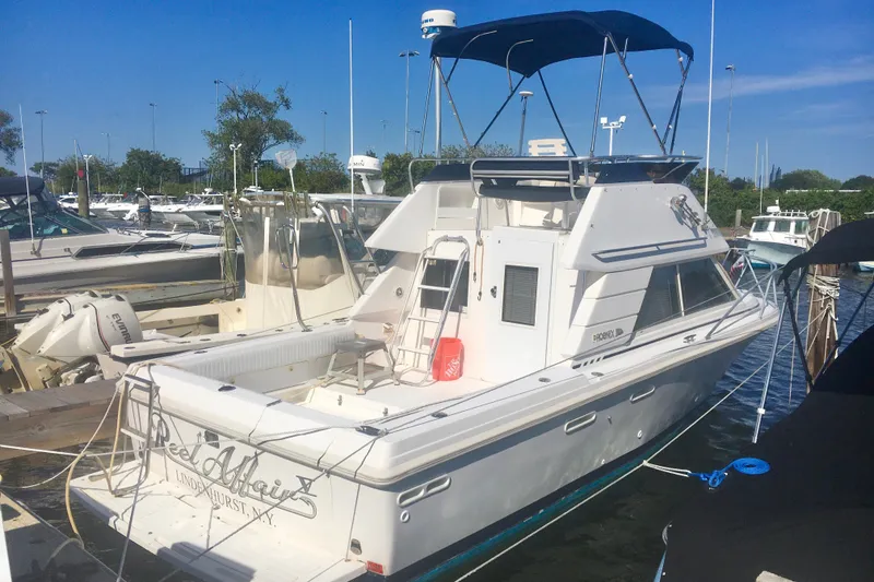 Slide: The Image of 2000 Phoenix 29 SFX boat docked at marina under clear blue sky. - 3