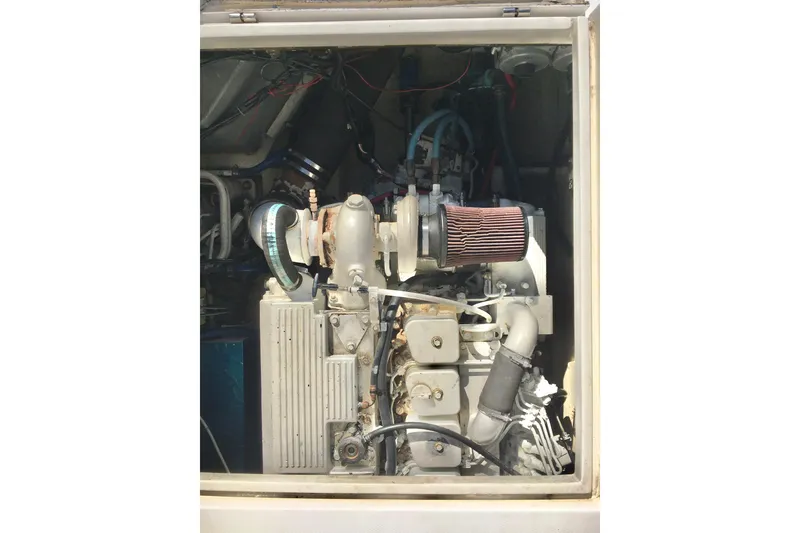 Slide: The Image of Engine compartment of a 2000 Phoenix 29 SFX boat, showcasing mechanical components. - 30