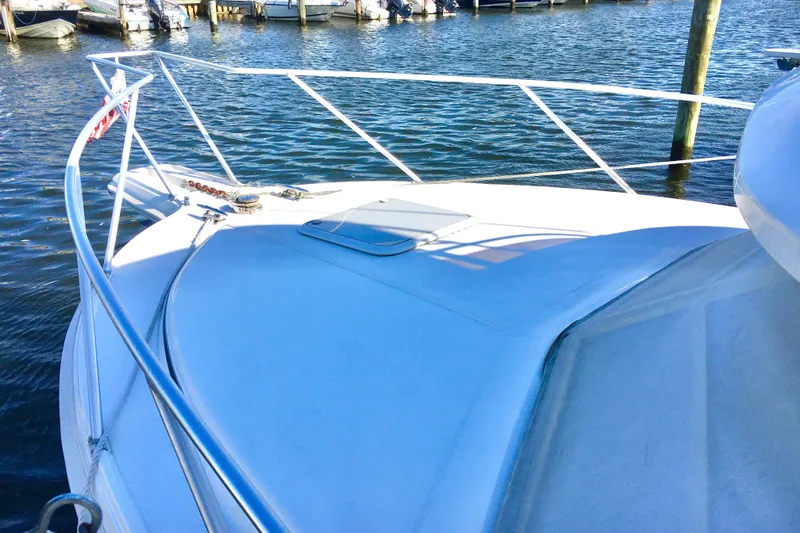 Slide: The Image of 2000 Phoenix 29 SFX boat docked on calm water, showcasing sleek design. - 4