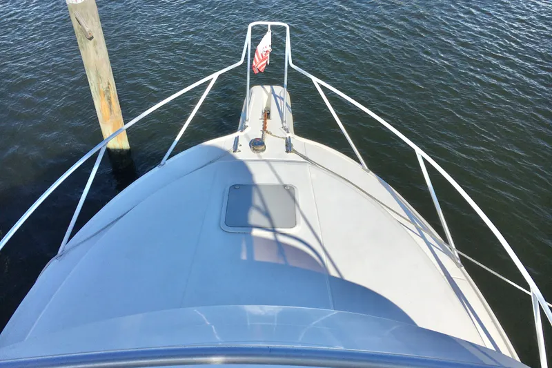 Slide: The Image of Bow view of 2000 Phoenix 29 SFX boat docked on calm water. - 6