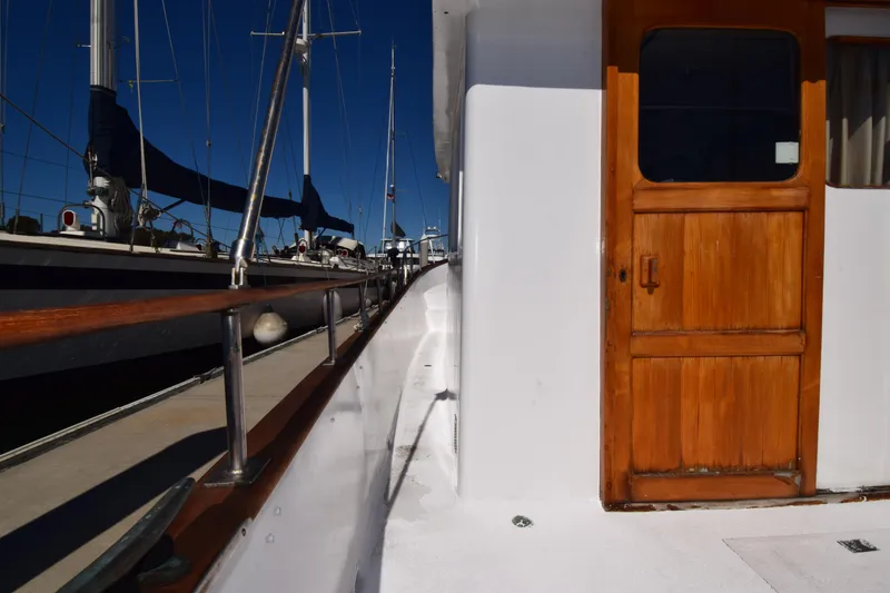 Slide: The Image of Side view of a 1972 CHB 34 boat with wooden door and railing. - 11