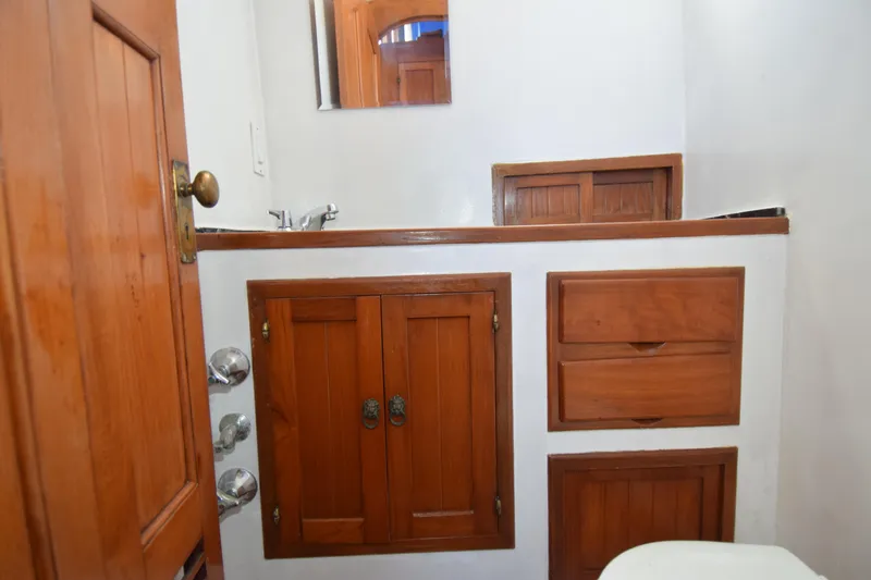 Slide: The Image of Wooden bathroom cabinetry in a 1972 CHB 34 boat, featuring a sink and mirror. - 18