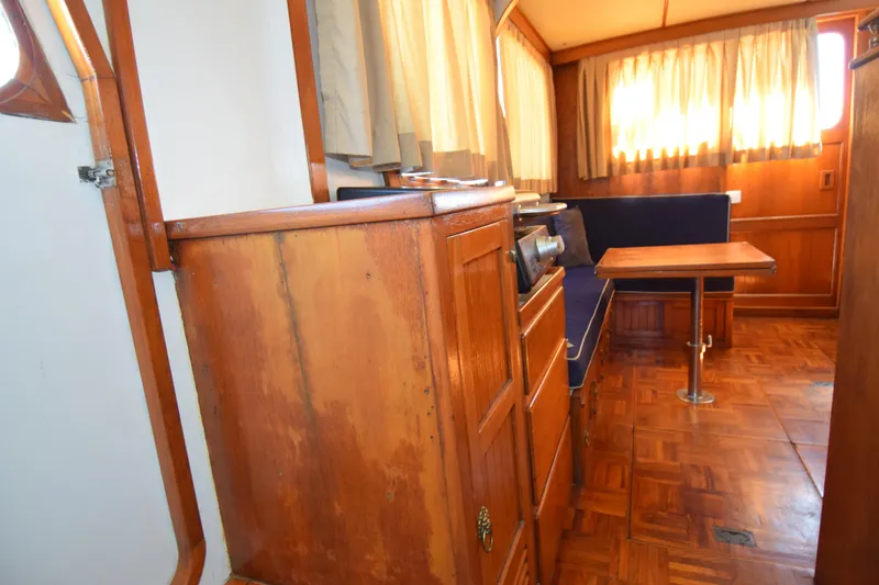 Slide: The Image of Interior of a 1972 CHB 34 boat with wooden cabinetry and seating area. - 21
