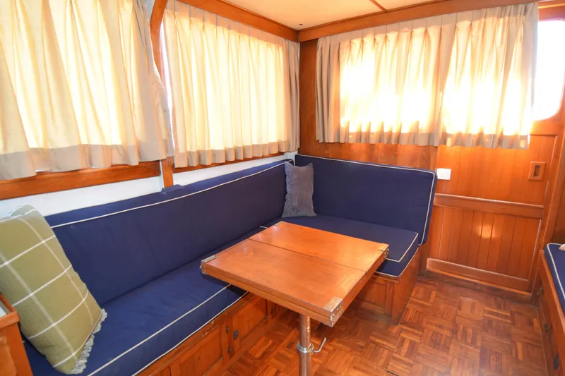 Slide: The Image of Interior of 1972 CHB 34 boat with blue seating and wooden table. - 23