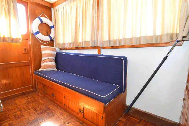 Slide: The Image of Interior of a 1972 CHB 34 boat with blue cushioned seating and life preserver. - 24