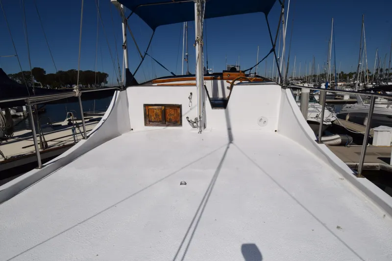 Slide: The Image of 1972 CHB 34 boat deck with blue canopy, docked in marina. - 26