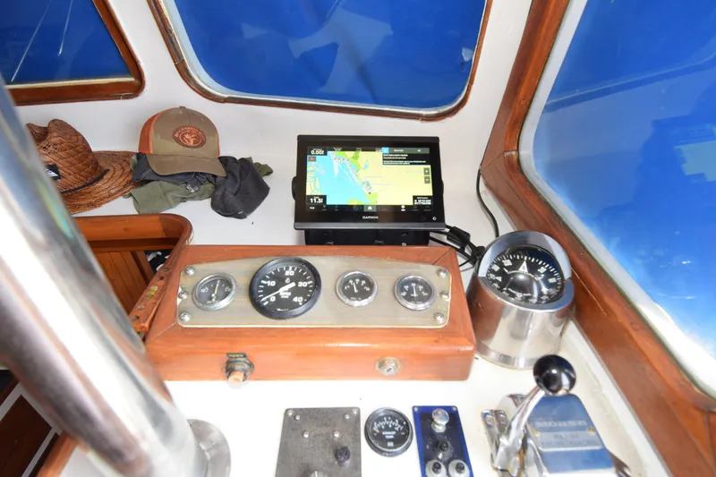 Slide: The Image of 1972 CHB 34 boat cockpit with navigation instruments and GPS display. - 7