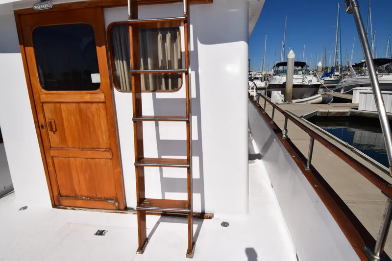 Slide: The Image of Wooden door and ladder on 1972 CHB 34 boat docked at marina. - 9