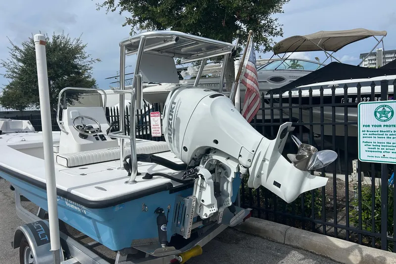 Slide: The Image of 2025 Piranha Magro P180 boat with Suzuki outboard motor, parked near a fence. - 3