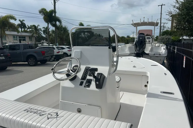 Slide: The Image of 2025 Piranha Magro P180 boat with steering console, parked outdoors. - 6