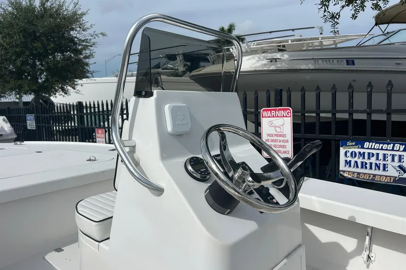 Slide: The Image of 2025 Piranha Magro P180 boat console with steering wheel and warning sign. - 9
