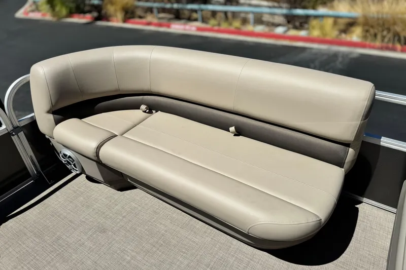 Slide: The Image of 2025 Sun Tracker Party Barge 16 DLX, beige seating, outdoor setting. - 11