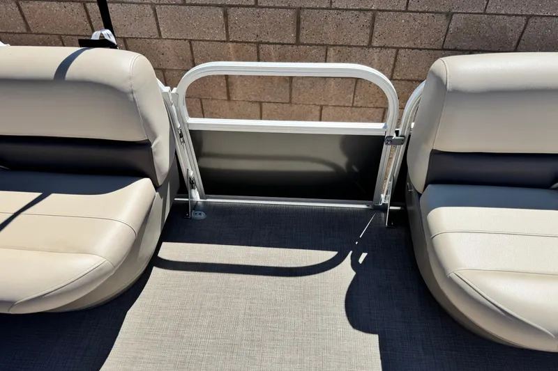 Slide: The Image of 2025 Sun Tracker Party Barge 16 DLX interior seating with gate, beige upholstery. - 13
