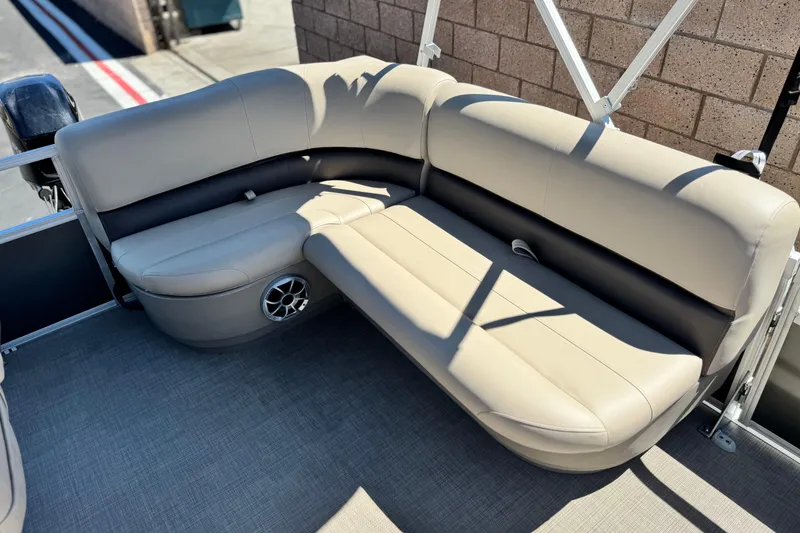 Slide: The Image of 2025 Sun Tracker Party Barge 16 DLX with beige seating and speaker detail. - 14