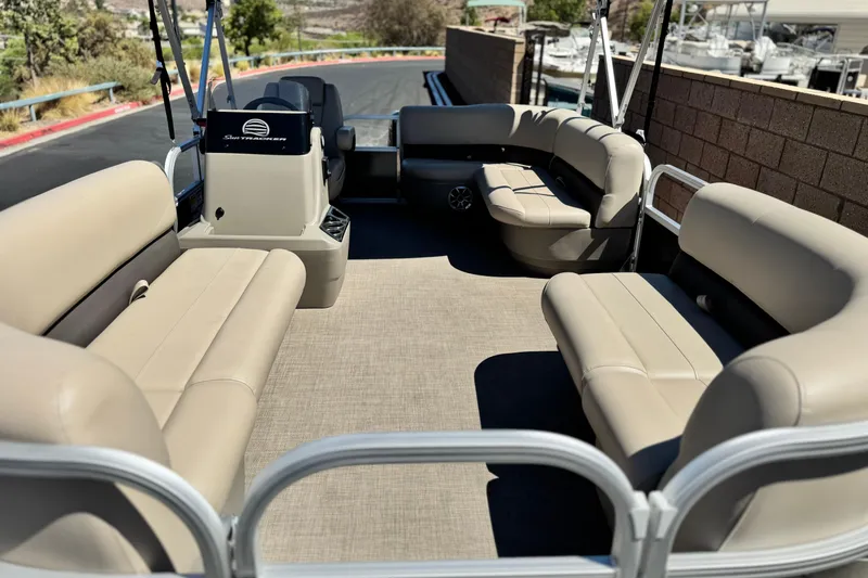 Slide: The Image of 2025 Sun Tracker Party Barge 16 DLX with beige seating and spacious deck layout. - 8