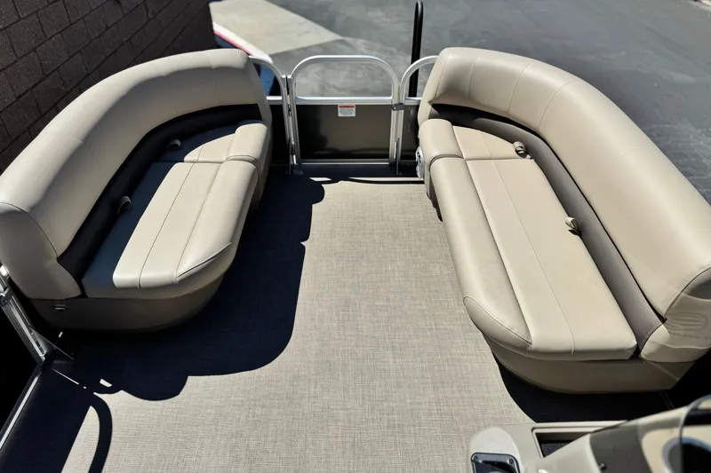 Slide: The Image of 2025 Sun Tracker Party Barge 16 DLX interior with beige seating and spacious layout. - 9