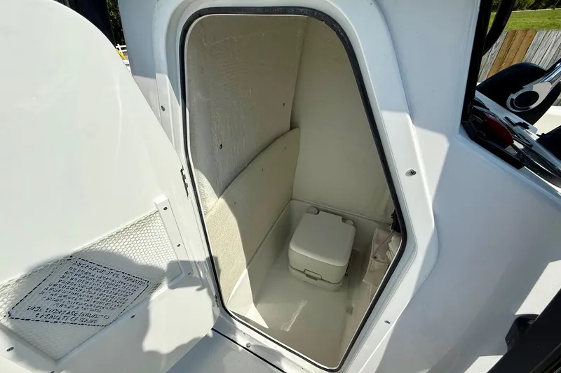 Slide: The Image of Compact marine toilet compartment in 2026 Sea Hunt Ultra 229 boat. - 13