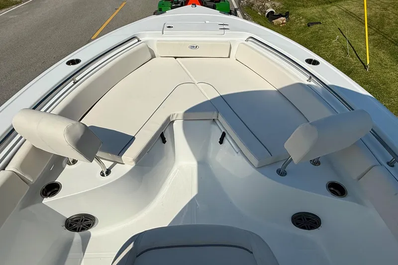 Slide: The Image of 2026 Sea Hunt Ultra 229 boat interior with cushioned seating and cup holders. - 14
