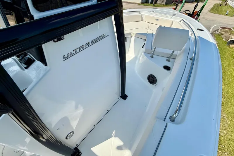Slide: The Image of 2026 Sea Hunt Ultra 229 boat interior with seating and railing. - 15