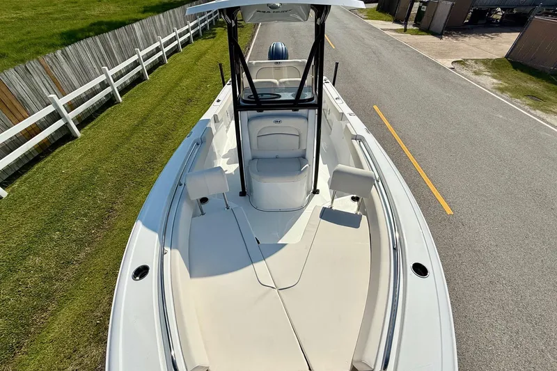 Slide: The Image of 2026 Sea Hunt Ultra 229 boat on road, top view, white interior, sunny day. - 16