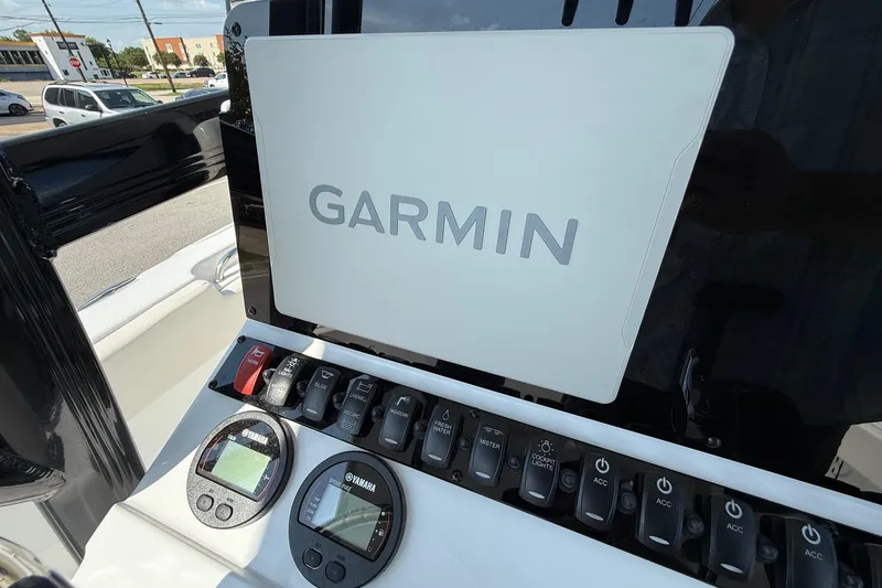 Slide: The Image of 2026 Sea Hunt Ultra 229 boat dashboard with Garmin navigation system and Yamaha controls. - 17
