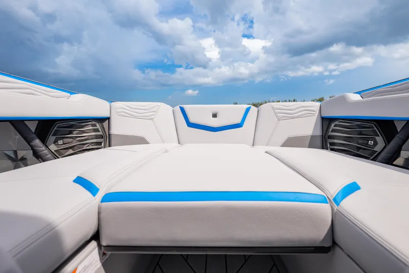 Slide: The Image of 2026 Nautique Super Air Nautique G23 interior with sleek white and blue upholstery under cloudy sky. - 10