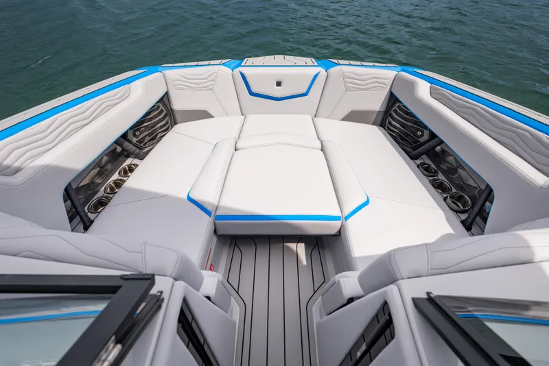 Slide: The Image of 2026 Nautique Super Air Nautique G23 boat interior with luxurious seating and cup holders. - 11