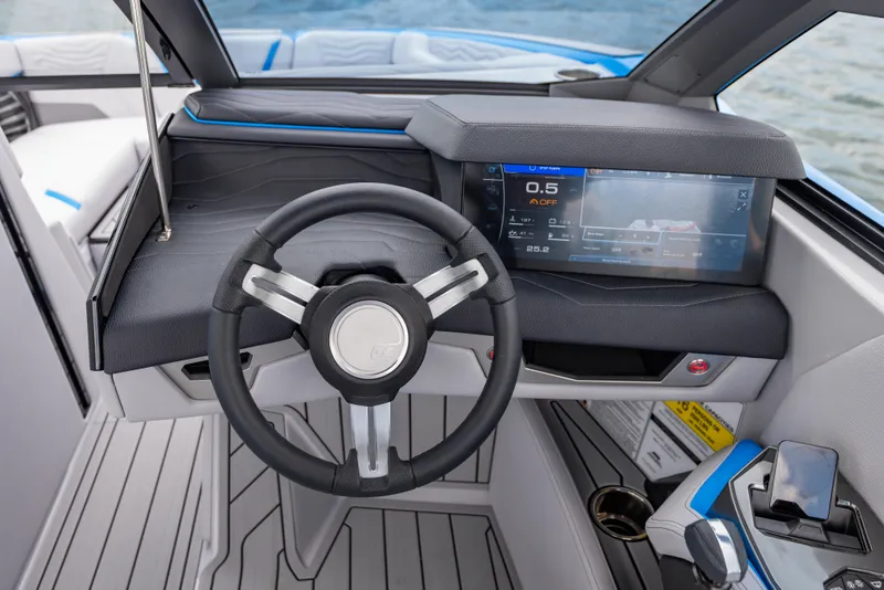 Slide: The Image of 2026 Nautique Super Air Nautique G23 dashboard with steering wheel and touchscreen display. - 16