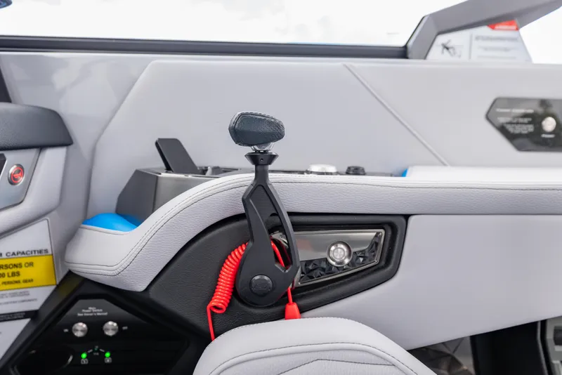 Slide: The Image of Interior of 2026 Nautique Super Air Nautique G23 boat, featuring control panel and throttle. - 18