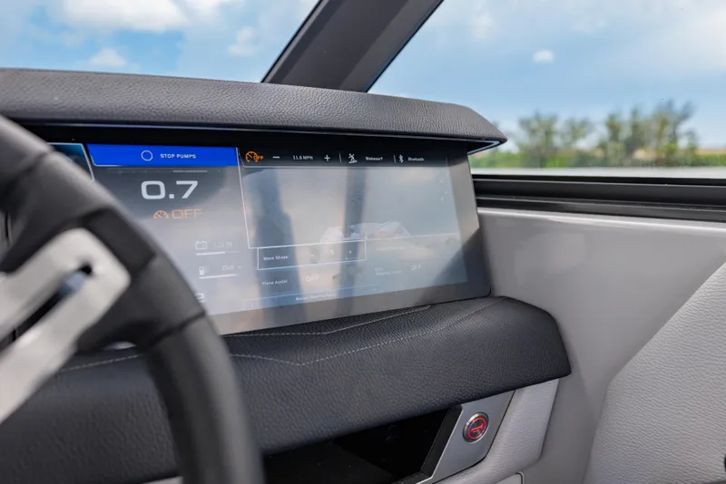 Slide: The Image of 2026 Nautique Super Air Nautique G23 dashboard with digital display and steering wheel. - 19