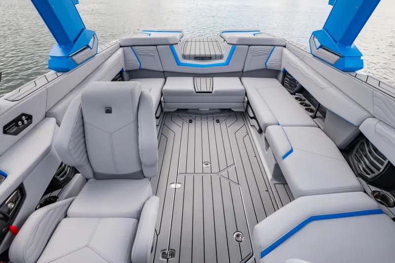 Slide: The Image of 2026 Nautique Super Air Nautique G23 interior with sleek gray seating and blue accents. - 2
