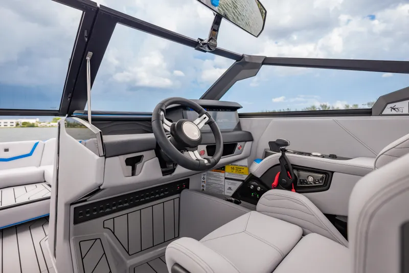 Slide: The Image of 2026 Nautique Super Air Nautique G23 boat interior with modern steering and controls. - 21