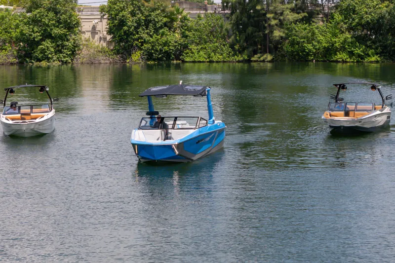 Slide: The Image of 2026 Nautique Super Air Nautique G23 boats on a serene lake. - 28