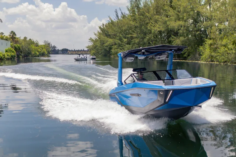 Slide: The Image of 2026 Nautique Super Air Nautique G23 cruising on a scenic waterway. - 34