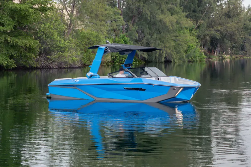 Slide: The Image of 2026 Nautique Super Air Nautique G23 boat in serene lake setting. - 39