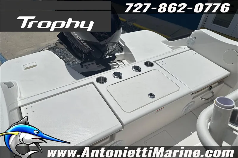 Slide: The Image of 2026 Trophy T22 Center Console boat interior with fishing rod holders and storage compartments. - 28
