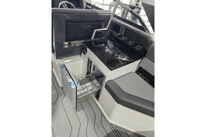Slide: The Image of 2026 Cobalt A29 boat interior with sleek black countertop and open storage drawer. - 18